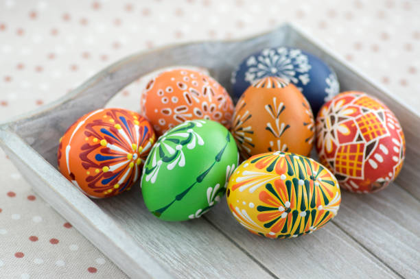 istock Group of wax painted Easter eggs on light grey tray 1196639692