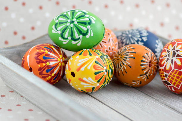 istock Group of wax painted Easter eggs on light grey tray 1196639740