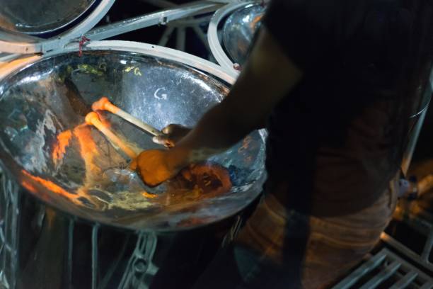 Steelpan practice Trinidad carnival night Port of Spain, Trinidad and Tobago, 11th February 2019. Drummer practicing for carnival with sticks and steelpan drum kit. steel drum stock pictures, royalty-free photos & images