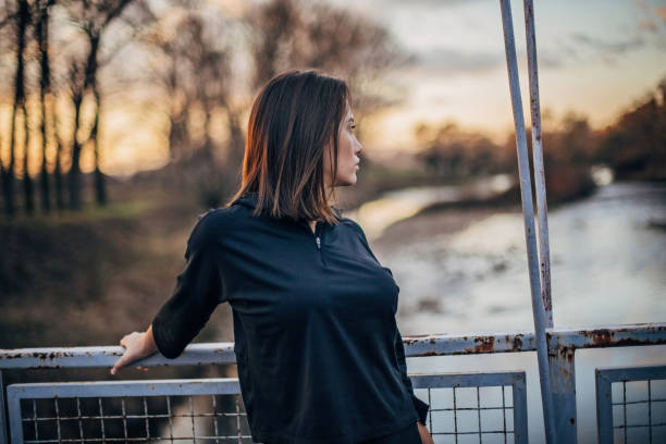 istock Young woman on the bridge 1196641085