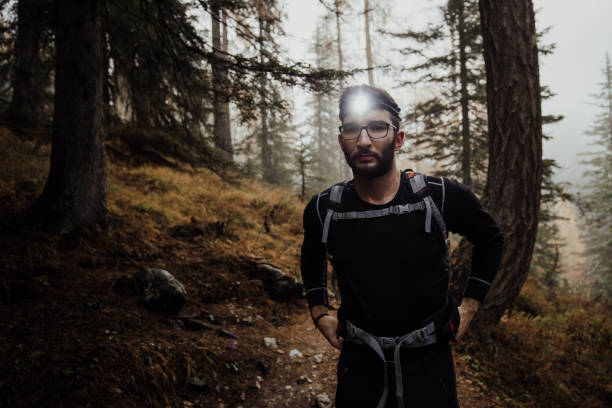Fit male hiker with a headlamp