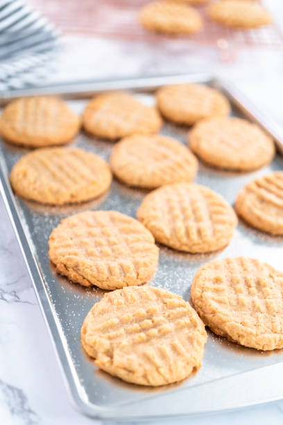 istock Freshly baked peanut butter cookies on a baking sheet. 1196645556