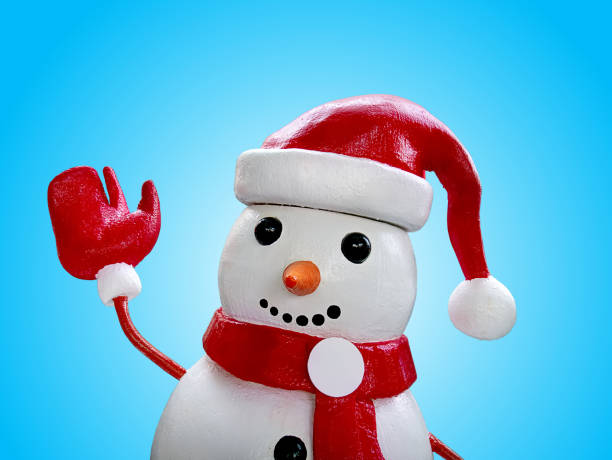 istock Close-up Snowman Doll Isolated on Blue Background 1196646325