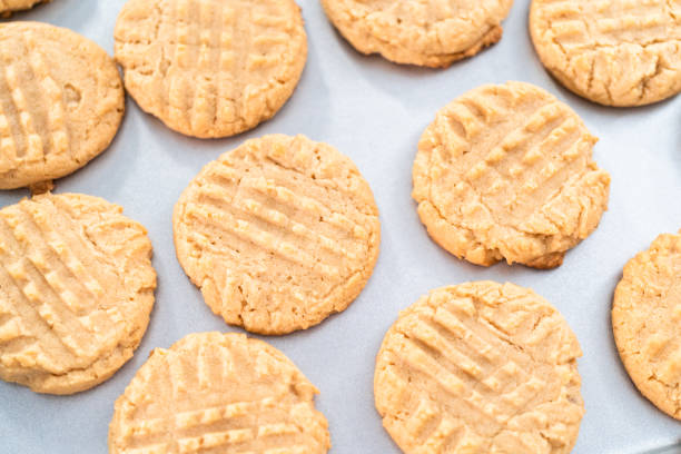 istock Freshly baked peanut butter cookies on a baking sheet. 1196646326