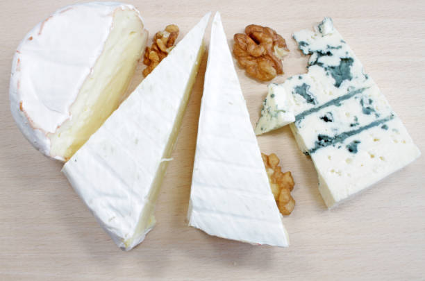 istock Soft cheese and blue cheese on a wooden board. 1196652289