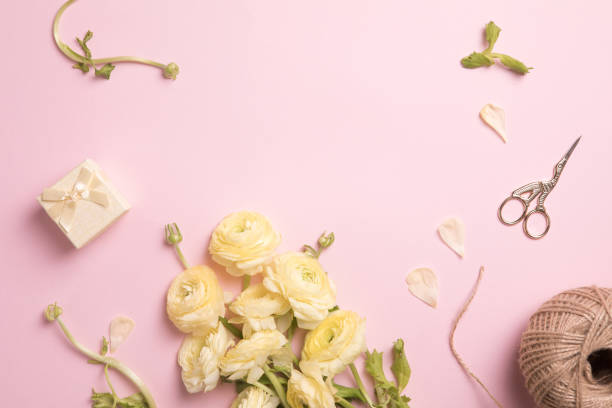 istock Beautiful spring flowers on pink background, flower frame composition 1196653089