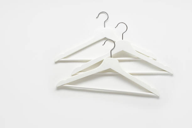 istock White monochromatic flatlay with wooden hangers on white background. 1196653632