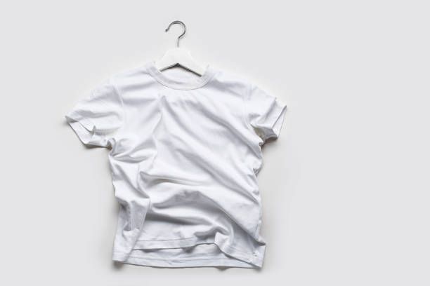 istock Flatlay with white t-shirt on white hanger on white background. 1196653636