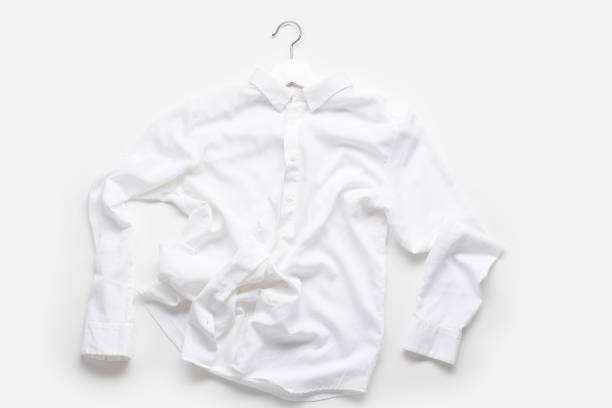 istock Flatlay with white shirt on white hanger on white background. 1196653637