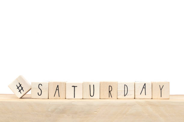 Wooden cubes with a hashtag and the word Saturday, social media concept near white background stock photo