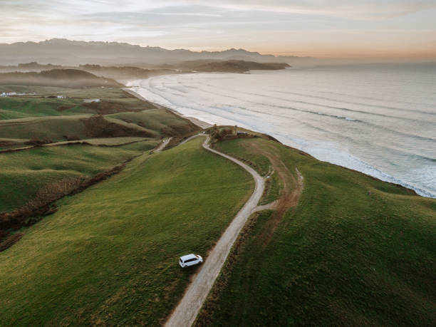 istock Road with curves by the sea at sunset 1196660652