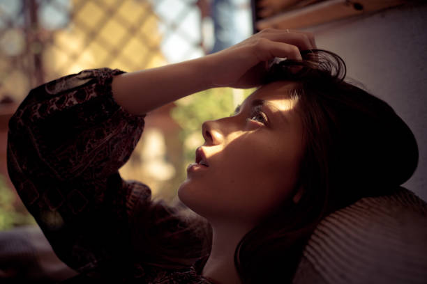 istock Girl sitting on the couch 1196662212