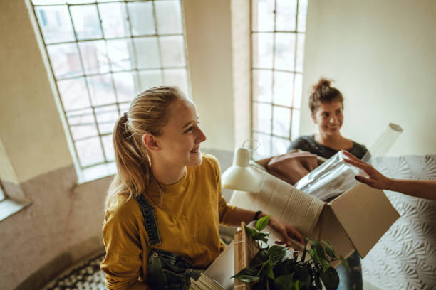 Flatmates are moving into a students dorm Photo of flatmates are moving into a students dorm dorm room photos stock pictures, royalty-free photos & images