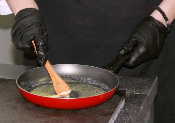 istock Butter melting in frying red pan 1196667616