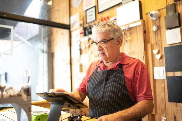 istock Focused cashier working in a restaurant 1196669693