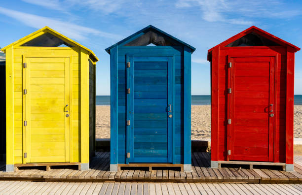 istock colorful beach cabins on a seaand and sandy bottom 1196672453