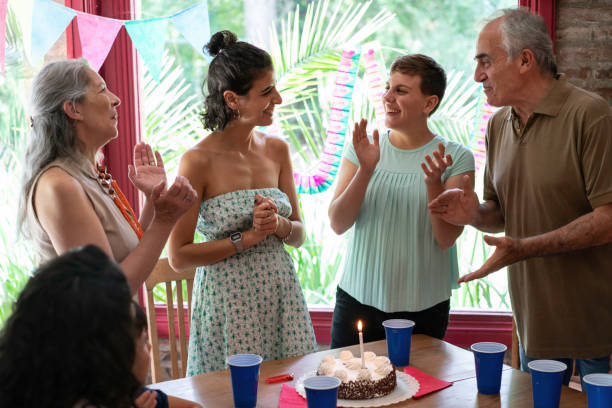 istock Caucasian woman blowing candles on cake 1196678990