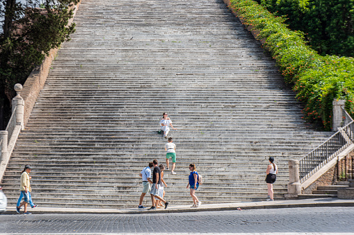 People walking in the Capitoline Hill zone next to the Campidoglio square. These stairs leading to the Church of Santa Maria in Aracoeli at Rome, Italy.