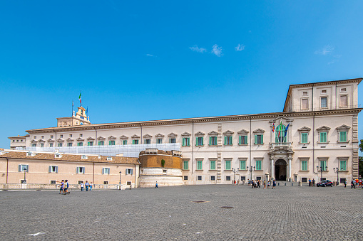 People walking outside the Quirinale building that holds the government authority in Rome, Italy.