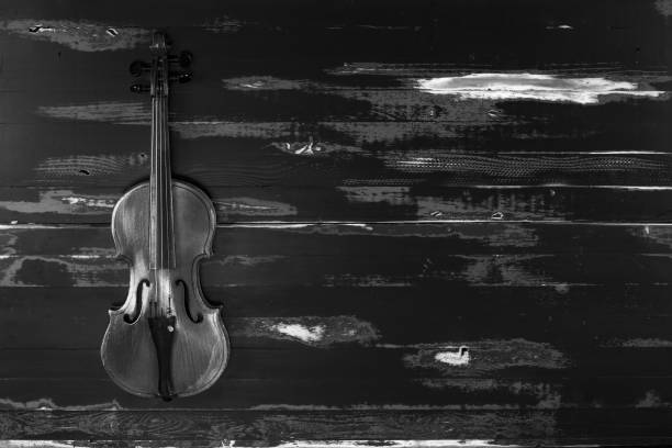 istock old violin on black wooden background 1196681952