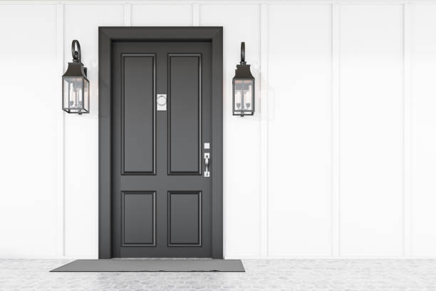 Stylish black front door of modern house with white walls, gray doormat and two beautiful lamps. 3d rendering