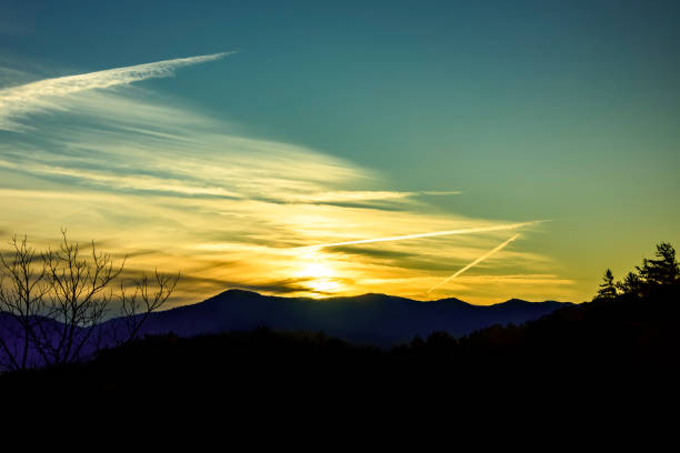 Mountain silhouette and contrail during a sunset in North Carolina
