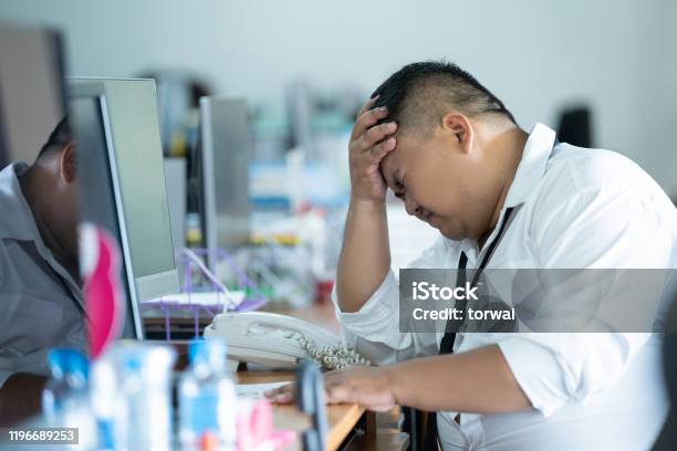The Employee Was Unemployed And Was Fired He Was In A Feeling Of Regret And Headache Stock Photo - Download Image Now
