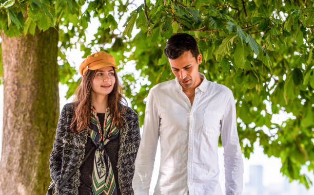 Portrait of young couple in sports clothing embracing outdoors