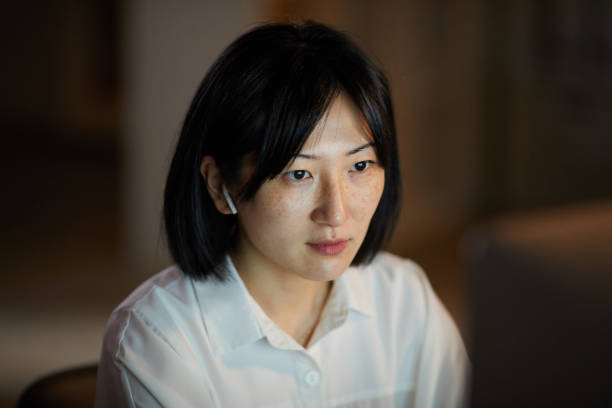 istock Asian woman working in the evening 1196691835