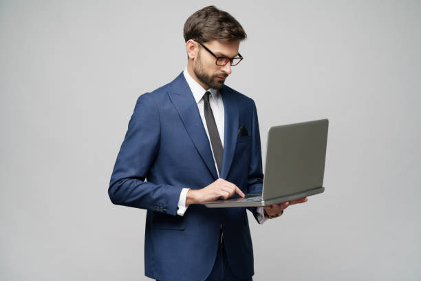 istock Young handsome businessman Holding a laptop Computer with Blank Screen 1196693158
