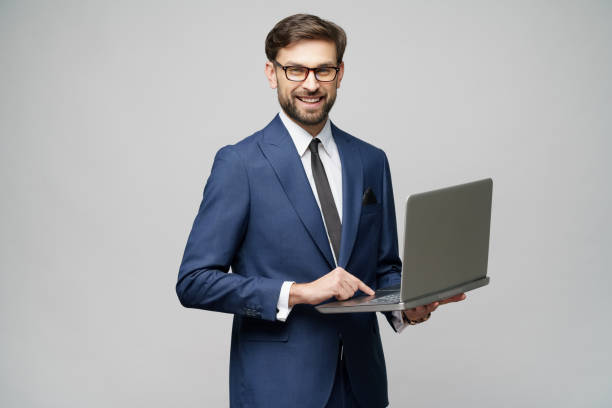 istock Young handsome businessman Holding a laptop Computer with Blank Screen 1196693164