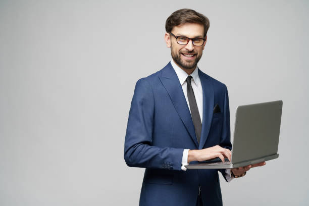 istock Young handsome businessman Holding a laptop Computer with Blank Screen 1196693166