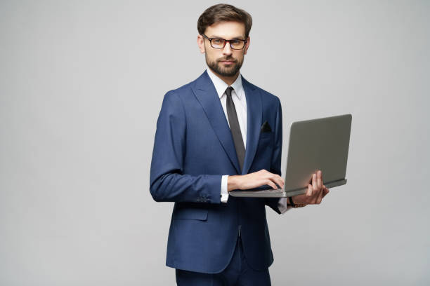 istock Young handsome businessman Holding a laptop Computer with Blank Screen 1196693168