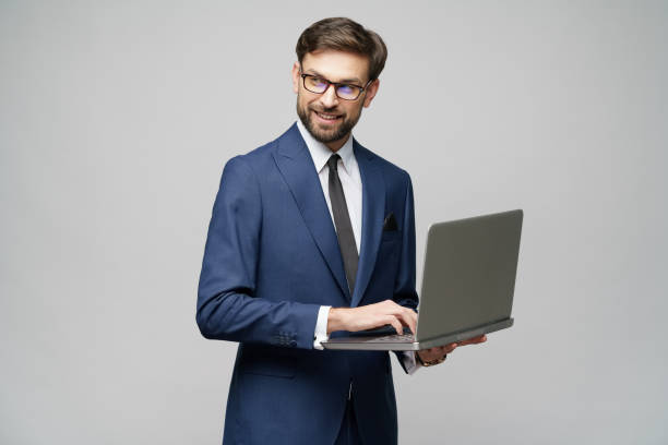 istock Young handsome businessman Holding a laptop Computer with Blank Screen 1196693170