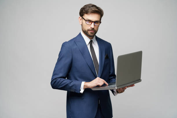 istock Young handsome businessman Holding a laptop Computer with Blank Screen 1196693183