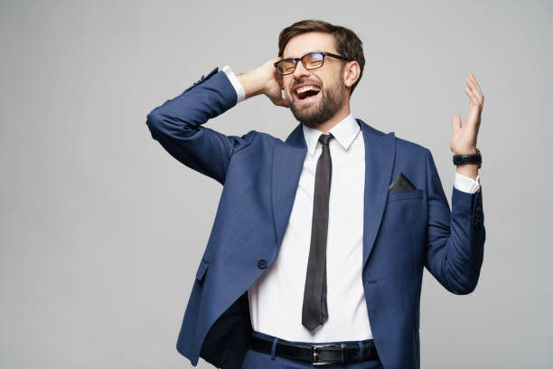 istock Very happy successful winner gesturing businessman over grey background 1196693206