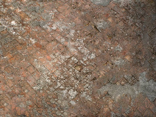 istock A crumbling old road paved by a square stone in orange .Texture or background. 1196695544