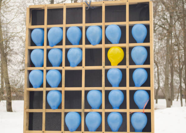 globos de colores en un banco de madera - rubber dart fotografías e imágenes de stock