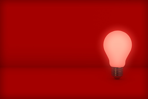 3d rendering of leadership and different creative idea concepts. Red shiny light bulb on red background. Realistic light bulbs idea banner on abstract scene with place for text.