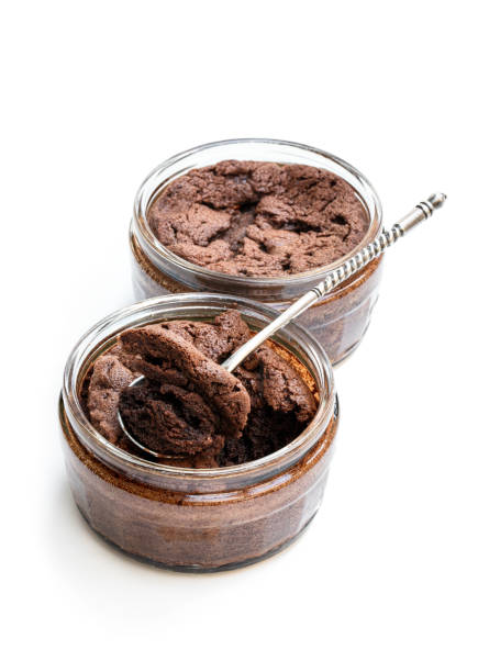 Homemade delicious chocolate souffle in glass jars isolated on white Homemade  delicious chocolate souffle in glass jars isolated on white cake jar stock pictures, royalty-free photos & images
