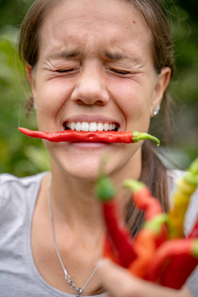 Red Hot Chilli Pepper in woman's mouth