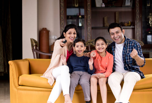 istock Family watching TV 1196705525