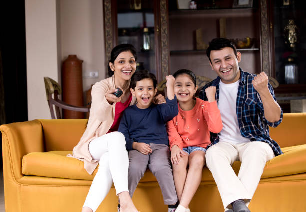 istock Family watching TV 1196705554