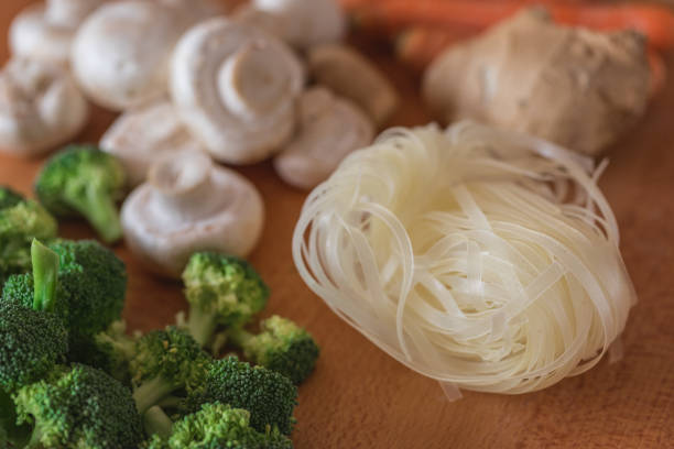 Asian glass noodle with raw vegetables on table, preparing vegan dish
