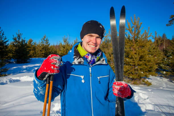 istock handsome man with skis in  winter forest 1196710395