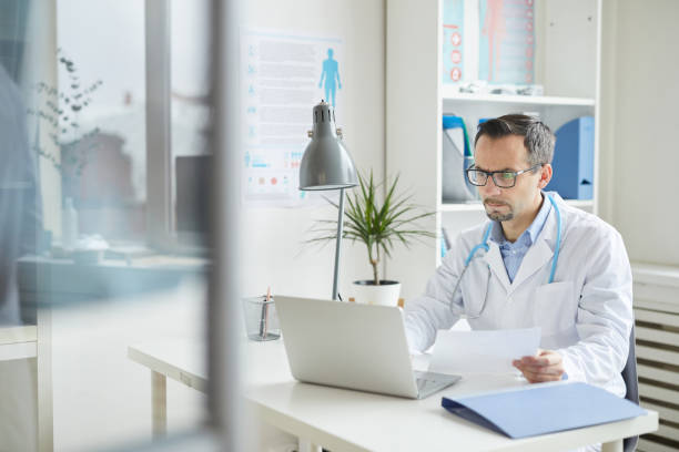 istock Doctor working on laptop at office 1196710549