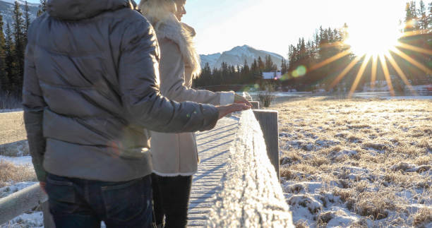 istock Mature couple walk along boardwalk in winter 1196710562