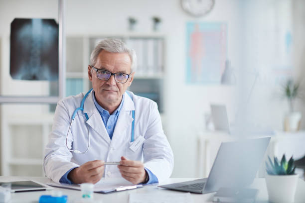 Serious senior doctor at his workplace