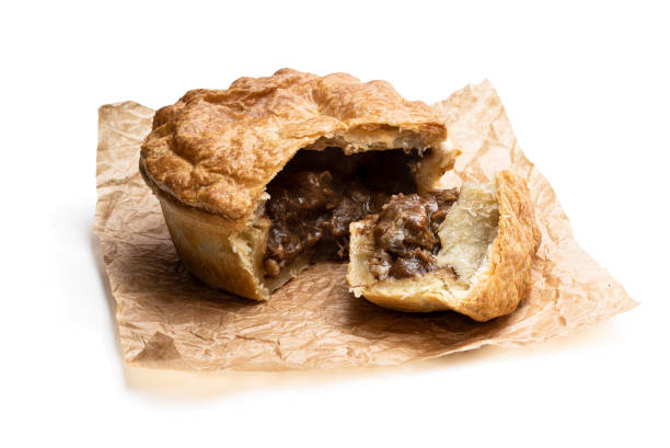 istock Puff pastry steak pie on baking paper isolated on white 1196711888