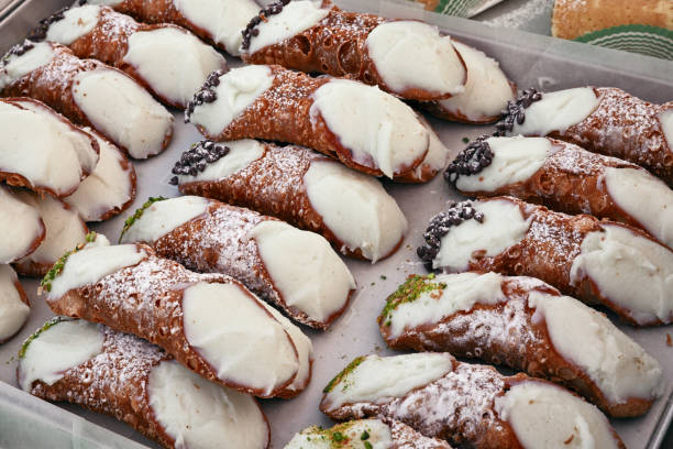 Italian cannoli, traditional sicilian dessert Italian cannoli, traditional sicilian confectionery product made with fried pastry dough filled with creamy, ricotta, almond, chocolate, fruit, candy, pistachios cannoli photos stock pictures, royalty-free photos & images